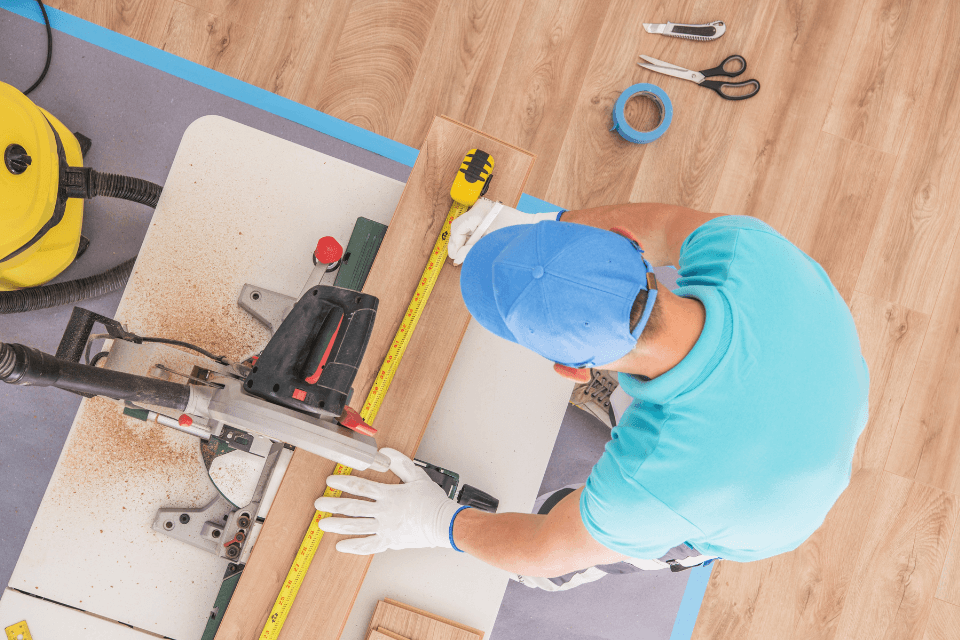 reasons why hiring a licensed remodeler is important contractor measuring flooring custom built michigan