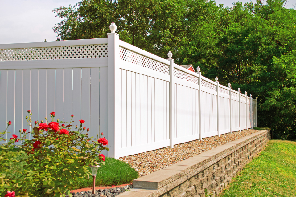 comparing common fencing materials vinyl fence with rock masonry wall custom built michigan