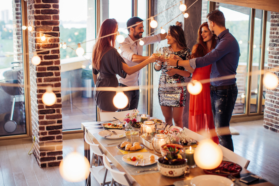 tips to prepare your home for an election party couples toasting in front of dining room table custom built michigan