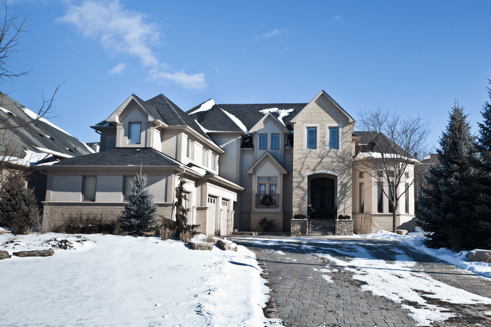 essential winterizing tips for your michigan home long driveway with snow and multi story house custom built okemos