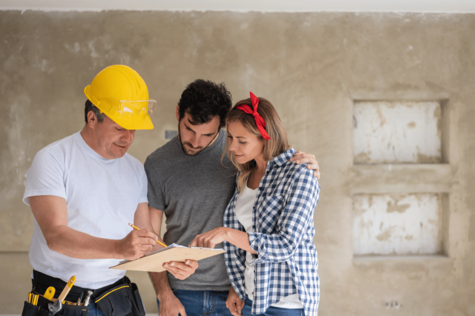 ways to give your remodeling contractor more clarity during a project remodeler and homeowners reviewing design custom built michigan