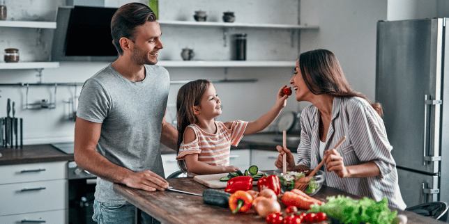 how to plan a remodel that fits your familys lifestyle parents and daughter preparing dinner in kitchen custom built michigan